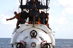 Crew give hand signals on Alvin launch