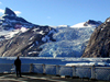 A tidewater glacier in Prinz Christian Sound on the southern tip of Greenland calves small bergy-bits as the USGC icebreaker Healy passes by.