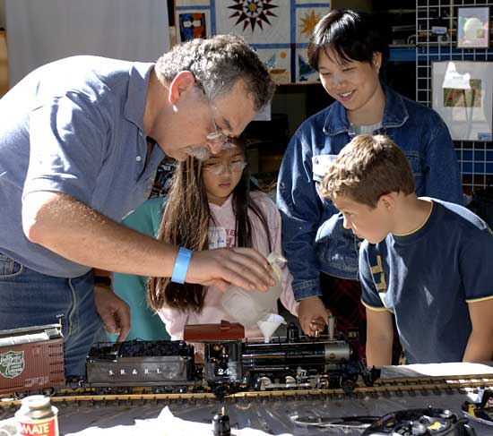 Ken Brink demonstrating his model trains as part of the employee arts and crafts exhibit at the Employee Recognition Celebration.