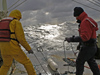 Veteran seagoing WHOI researchers Craig Marquette (left) and Will Ostrom deploy a mooring with tiny temperature probes from R/V Oceanus during a gale off Cape Hatteras