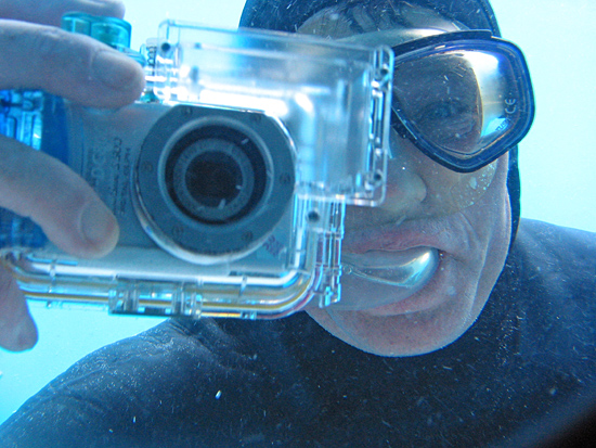 WHOI diver snapping photos of DSV Alvin crew through a view port.