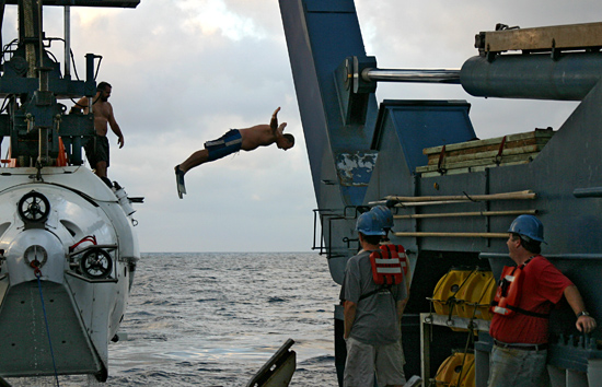 R/V Atlantis Steward Carl Wood leaps from DSV Alvin during launch.