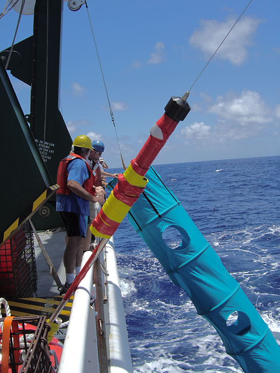 Researchers retrieve a sediment trap mooring with a ?holey sock? drogue