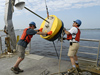 Postdoc Dave Ralston and Jay Sisson recover a mooring bouy.
