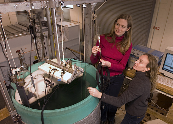 Tetjana Ross (in red) and Andone Lavery working with large test tank.