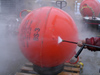 John Kemp powerwashing the mooring spheres.