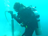 Diver underwater coral coring in Honduras