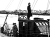 Captain Adrian K. Lane standing on the wheelhouse of R/V Atlantis, circa 1946.