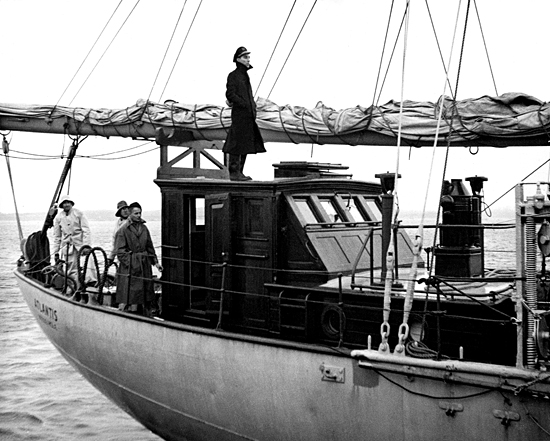 Captain Adrian K. Lane standing on the wheelhouse of R/V Atlantis, circa 1946.