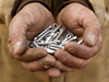 A handful of fasteners held by a crewman.