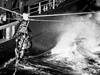 Fritz Hess transfers by highline from USS Hazelwood to Atlantis II during the Thresher search.