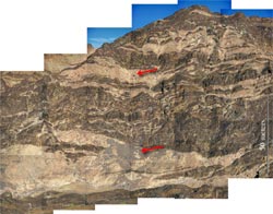 WHOI scientists Peter Kelemen (top arrow) and Greg Hirth (about 50 meters directly below) are walking on rocks that once were in the upper mantle beneath the seafloor.