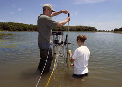 WHOI Postdoctoral Scholar Kevin Kroeger and Guest Student Kayla Halloran install a well in Eastham, Mass.