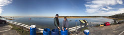 Assistant Scientist Jeff Donnelly holds a core of mud and sediment pulled up from a marsh.