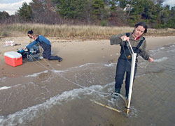 WHOI Assistant Scientist Ann Mulligan (foreground), Research Assistant Meagan Gonneea (blue shirt), and visiting student Claudette Spiteri collect data about groundwater discharge into Waquoit Bay, Mass.