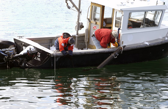 WHOI Associate Scientist Rob Evans (left) works with Engineering Assistant Matthew Gould to test a seafloor electromagnetic surveying instrument.