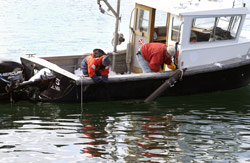 WHOI Associate Scientist Rob Evans (left) works with Engineering Assistant Matthew Gould to test a seafloor electromagnetic surveying instrument.