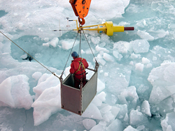 WHOI engineer in basket over ice