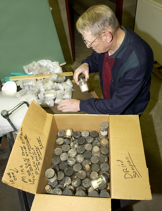 George LeRoy packs Mary Sears' Dana samples.