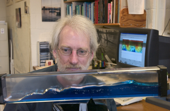 Scientist Tim Duda demonstrates with a wave tank what it is difficult to see in the ocean.