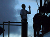 Silhouette of Biology Joint Program student Carly Strasser waving so long before boarding Alvin.