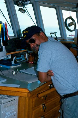 Chief Mate Diego Mello on Bridge; Dive Boat in Distance