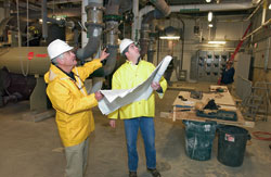 Bill McKeon (left), WHOI?s director of shore operations, reviewed blueprints with a construction project manager.