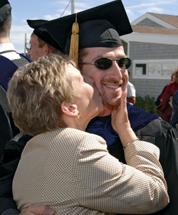 MIT/WHOI graduate student Mike Braun gets his Ph.D. diploma?and a kiss from mom