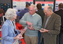 Ocean Life Institute Director Larry Madin (center) displays jellyfish to Lisina and Frank Hoch at the WHOI Trustees meeting in May.