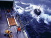 Scientists aboard R/V Knorr launch a rosette water sampler and conductivity/temperature/depth instrument. Much of the data discussed in this issue was collected by such equipment. Author McCartney is the fellow getting wet at top left.