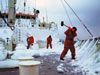 Captain A.D. Colburn, right, crew member Bill Dunn, and others wield their ice mallets on <em>Knorr's</em> foredeck during the Labrador Sea cruise.