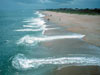 Waves, currents, sand grain sizes, sandbar configurations, water table levels beneath the beach, and other phenomena combine in complex ways, causing very different patterns along the same beach.