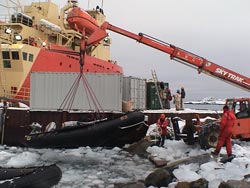 Several inflatable boats were used during the seafloor survey and needed to be taken out of the water almost daily to avoid ice damage. The <em>Laurence Gould</em> is in the background.