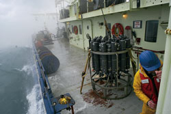 WHOI engineer Craig Marquette secures the door to the wet lab after recovery of a CTD (on deck)