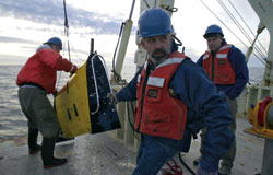 Gawarkiewicz, Will Ostrom, and Brian Kidd (right to left) recover the Scanfish, a towed vehicle that measures temperature and salinity.