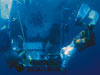Carl Wood (left), R/V Atlantis steward, and Ken Feldman, a shipboard technician, are also certified swimmers who help launch and recover the WHOI-operated deep-diving submersible Alvin. In the famed submersible?s 41-year history, only 35 people?with an underwater brand of the ?right stuff??have become Alvin pilots. 