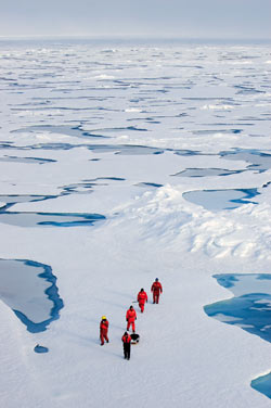 A party of scientists and crew returns to ship after installing an Ice-Tethered Profiler on an Arctic Ocean ice floe in August 2005.