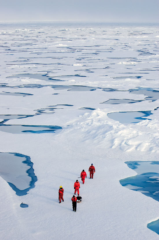 A party of scientists and crew returns to ship after installing an Ice-Tethered Profiler on an Arctic Ocean ice floe in August 2005.
