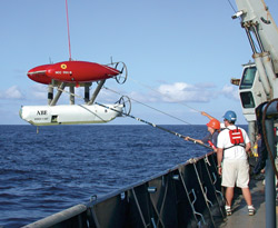 Crew members recover ABE aboard R/V Atlantis after a dive to detect hydrothermal vents on the Galapagos Rift in 2002.