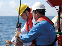 Jian Lin (yellow hard hat), a geophysicist at Woods Hole Oceanographic Institution, was U.S. chief scientist aboard two voyages of China's new research vessel