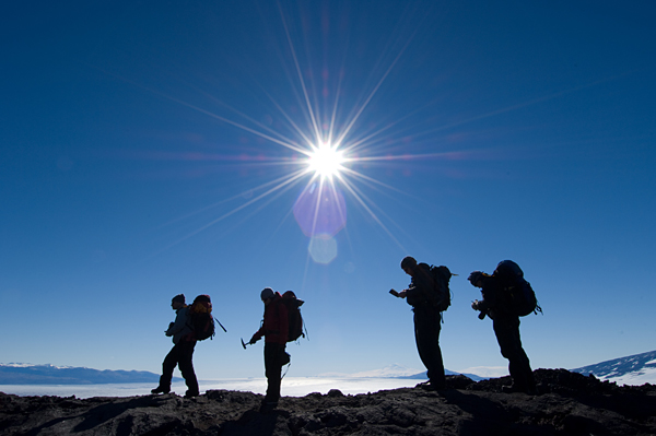 The field team hiking along a ridge.