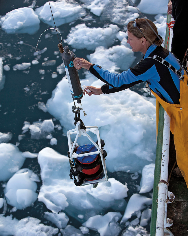 Physical oceanographer Ruth Curry draws a water sample from the bottom of Sermilik Fjord.