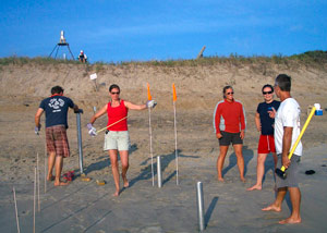 Rebecca Gast checks spacing of core sites on beach at Duck, N.C.