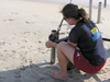 Elizabeth Halliday attaches winch collar to coring tube on beach in Duck, NC