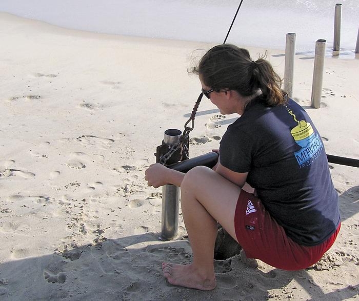 Elizabeth Halliday attaches winch collar to coring tube on beach in Duck, NC