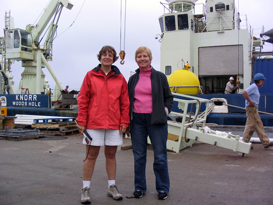 Amy Bower and Kate Fraser stand in front of R/V <em>Knorr</em> before departing on the cruise. 