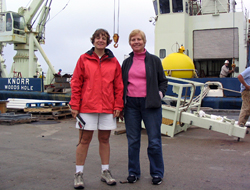 Amy Bower and Kate Fraser stand in front of R/V <em>Knorr</em> before departing on the cruise. 