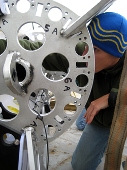 WHOI graduate studant Dave Sutherland loads a float into a SALP rosette.