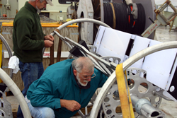 Jim Valdes and Will Ostrom spend the day getting the mooring ready. Here, they are loading a float into a SALP rosette.