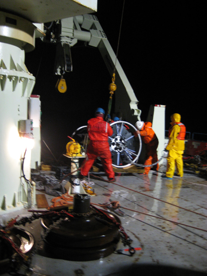 At around 1:00 a.m., EST, an hour or so after the yellow buoyancy sphere went overboard and the mooring deployment officially began, the crew wrestles the first of the two SALP frames into position.